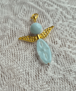 Een licht blauw geluksengeltje met gouden filigraan vleugels
